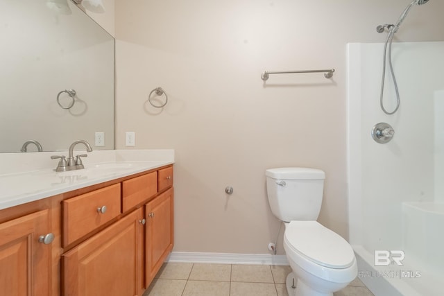 bathroom with vanity, toilet, baseboards, and a shower