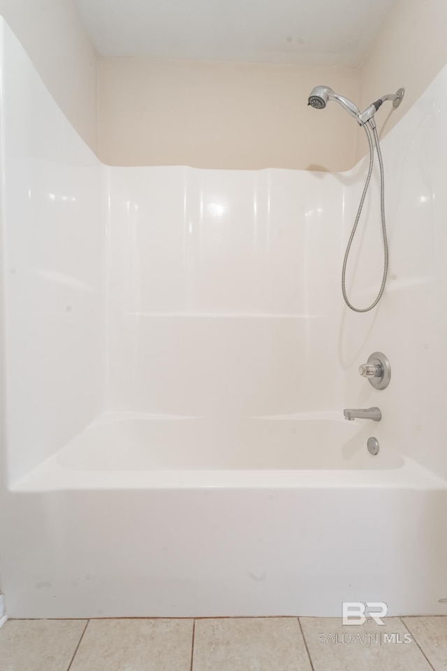 full bath featuring tile patterned flooring and shower / bathtub combination