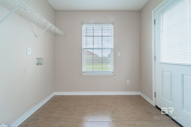 laundry area with washer hookup, baseboards, laundry area, and light wood finished floors