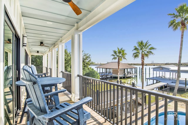 balcony featuring a water view and ceiling fan