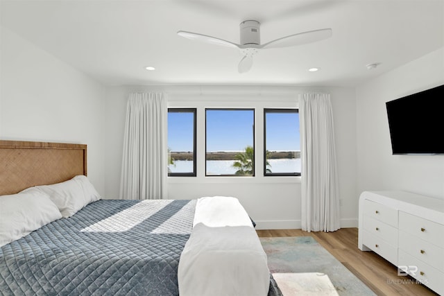 bedroom with light hardwood / wood-style floors and ceiling fan