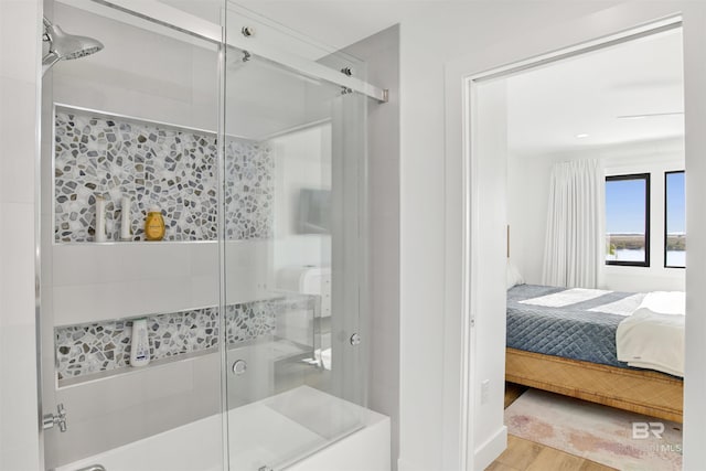 bathroom with a shower with shower door and hardwood / wood-style flooring