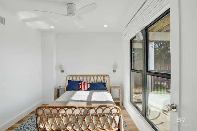 bedroom with hardwood / wood-style floors and ceiling fan