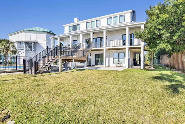 rear view of property with a yard and a patio