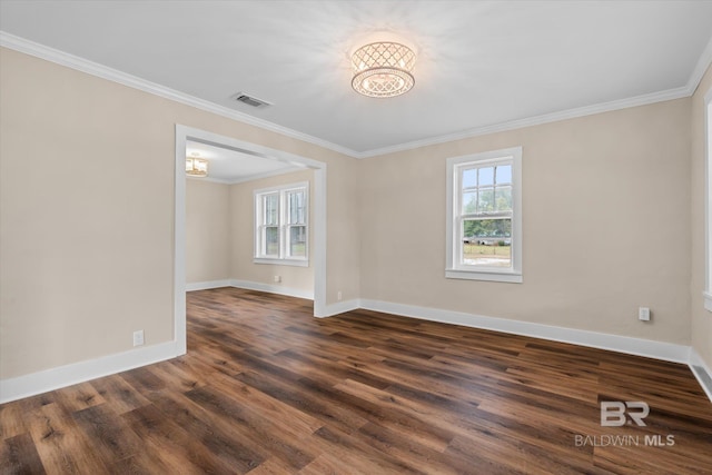 unfurnished room with dark hardwood / wood-style flooring, ornamental molding, and an inviting chandelier