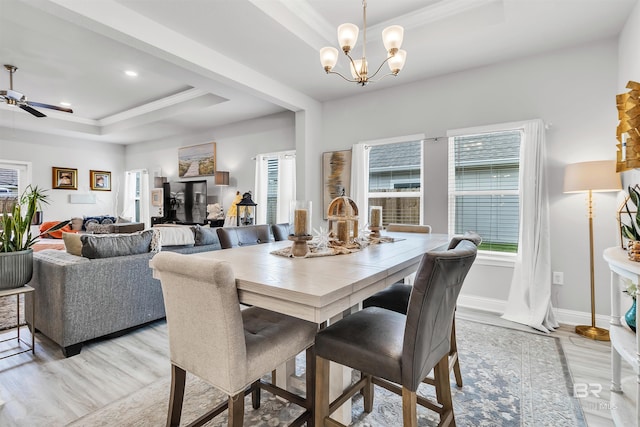 3905 Mercury Cir, Gulf Shores, AL 36542 - dining room with a tray ceiling, ornamental molding, plenty of natural light, and light wood-style floors