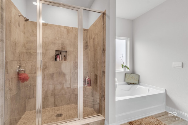 3905 Mercury Cir, Gulf Shores, AL 36542 - full bathroom with a garden tub, a shower stall, and baseboards