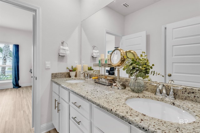 3905 Mercury Cir, Gulf Shores, AL 36542 - full bath with a sink, baseboards, visible vents, and wood finished floors