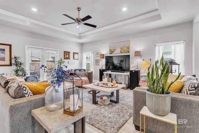 3905 Mercury Cir, Gulf Shores, AL 36542 - living area with light wood-style floors, a tray ceiling, ceiling fan, and plenty of natural light
