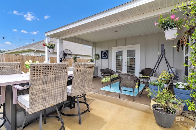 3905 Mercury Cir, Gulf Shores, AL 36542 - view of patio featuring french doors, outdoor dining area, an outdoor hangout area, and fence