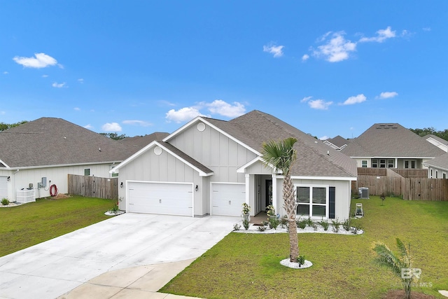3905 Mercury Cir, Gulf Shores, AL 36542 - view of front of house with board and batten siding, driveway, fence, an attached garage, and a front yard