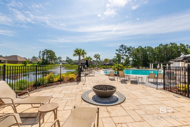 3905 Mercury Cir, Gulf Shores, AL 36542 - view of patio with fence, a water view, and a community pool