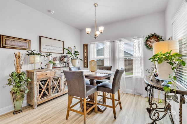 3905 Mercury Cir, Gulf Shores, AL 36542 - dining area featuring baseboards, light wood-style flooring, and a chandelier