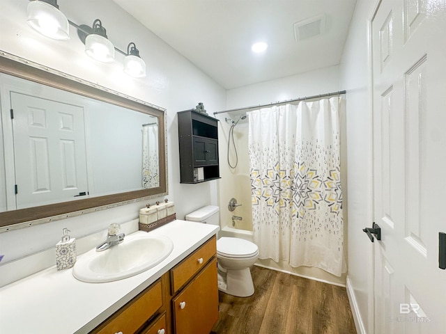 full bathroom featuring toilet, hardwood / wood-style flooring, shower / bath combo, and large vanity