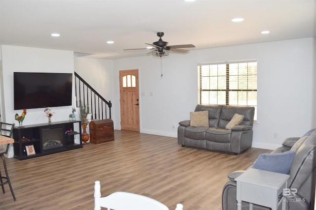 living room with hardwood / wood-style flooring and ceiling fan