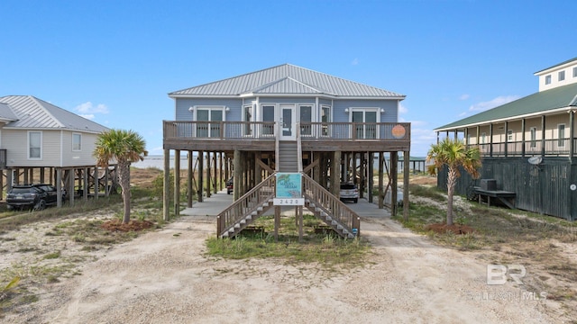 2420 Bienville Blvd, Dauphin Island, AL 36528 - view of front of property featuring a carport, metal roof, driveway, and stairway