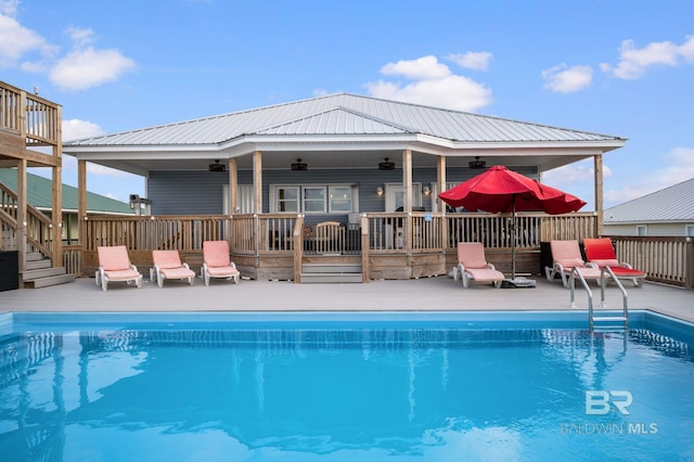 2420 Bienville Blvd, Dauphin Island, AL 36528 - view of swimming pool featuring stairs, a deck, and a patio