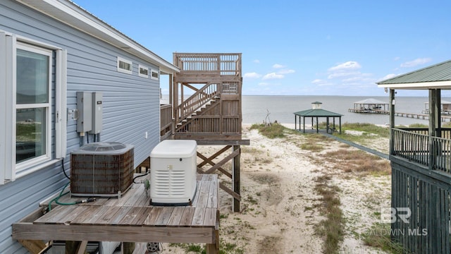 2420 Bienville Blvd, Dauphin Island, AL 36528 - wooden terrace with cooling unit, a gazebo, a water view, and stairway