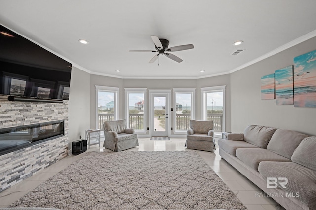 2420 Bienville Blvd, Dauphin Island, AL 36528 - tiled living room with a ceiling fan, plenty of natural light, ornamental molding, a fireplace, and recessed lighting
