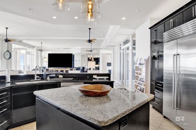 14237 Perdido Key Dr Unit Ph-1401, Pensacola, FL 32507 - kitchen with dark cabinets, a ceiling fan, light tile patterned floors, stainless steel built in fridge, and a center island