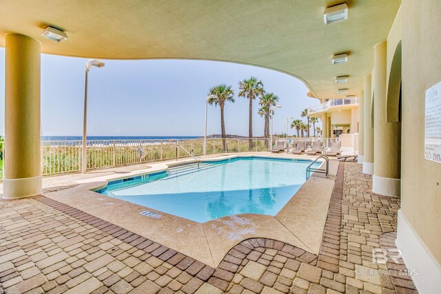 14237 Perdido Key Dr Unit Ph-1401, Pensacola, FL 32507 - pool with fence, a water view, and a patio