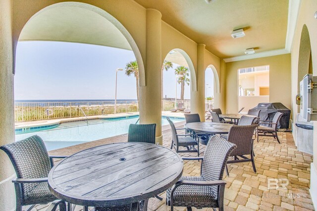 14237 Perdido Key Dr Unit Ph-1401, Pensacola, FL 32507 - view of patio featuring a community pool, fence, and outdoor dining space