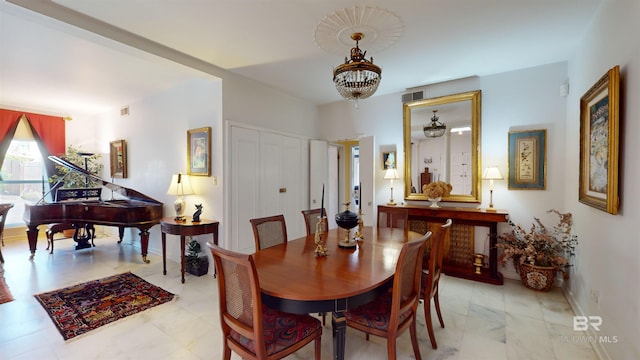 dining room with a notable chandelier