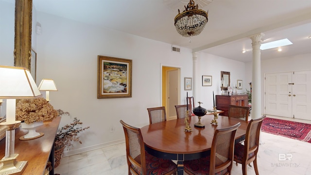 dining space featuring decorative columns