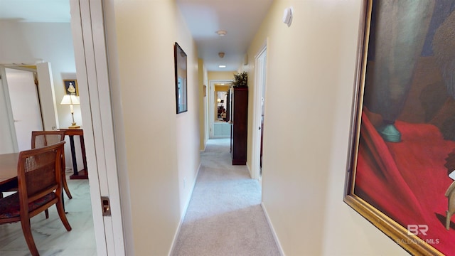 corridor featuring light colored carpet