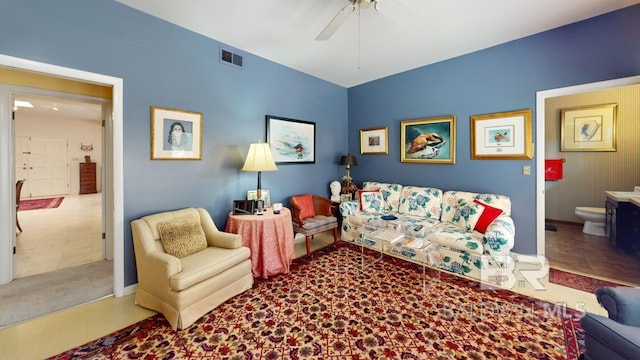 carpeted living room with ceiling fan