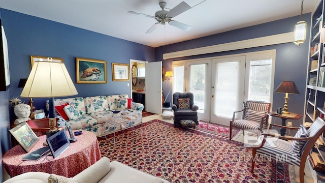 living room featuring french doors and ceiling fan