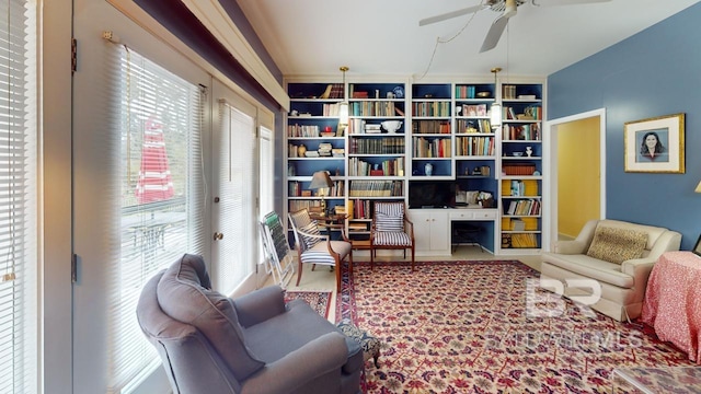 sitting room with plenty of natural light and ceiling fan