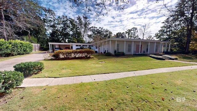 ranch-style home featuring a front yard