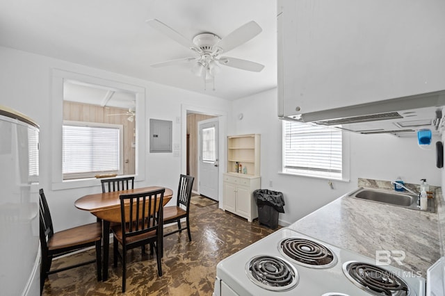 kitchen featuring dark tile patterned floors, electric panel, sink, and ceiling fan