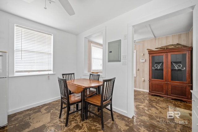 tiled dining room featuring electric panel and ceiling fan