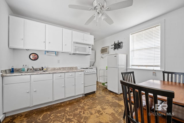 kitchen featuring ceiling fan, white cabinets, white appliances, a wall unit AC, and sink