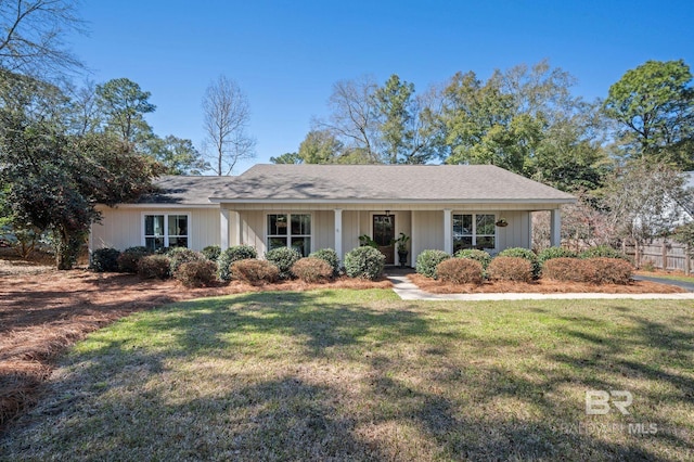 single story home with fence and a front lawn