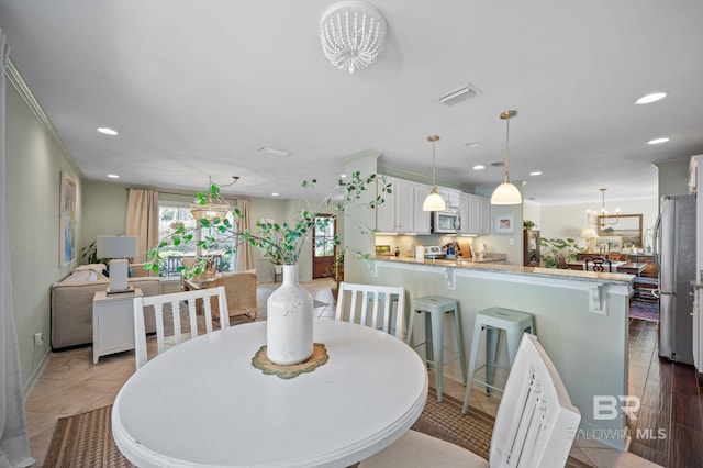 dining area featuring recessed lighting, visible vents, and an inviting chandelier