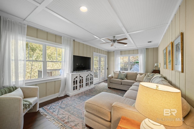 living area featuring coffered ceiling, wood finished floors, visible vents, and a ceiling fan