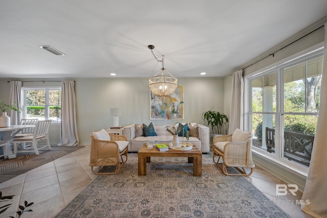 living area with visible vents, baseboards, an inviting chandelier, tile patterned flooring, and recessed lighting