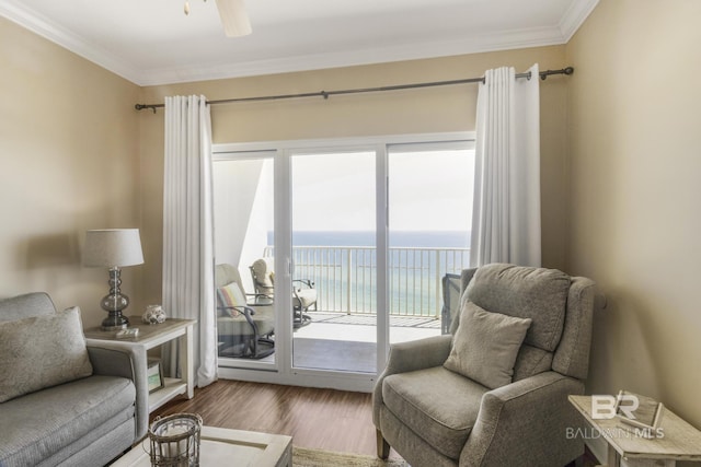 401 E Beach Blvd Unit 1704, Gulf Shores, AL 36542 - sitting room featuring wood finished floors, ornamental molding, a ceiling fan, and a water view
