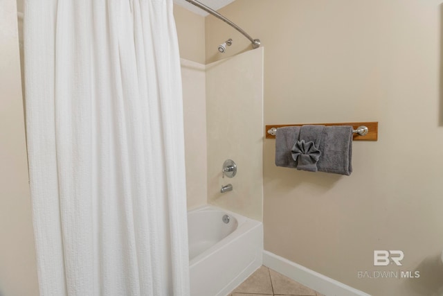 bathroom with shower / bath combo with shower curtain and tile patterned flooring