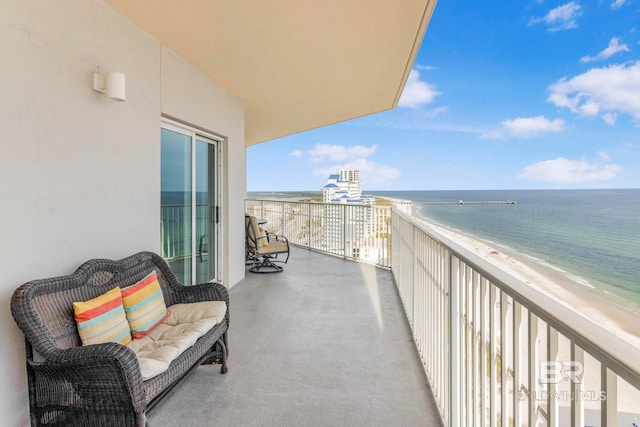 balcony with a water view and a beach view