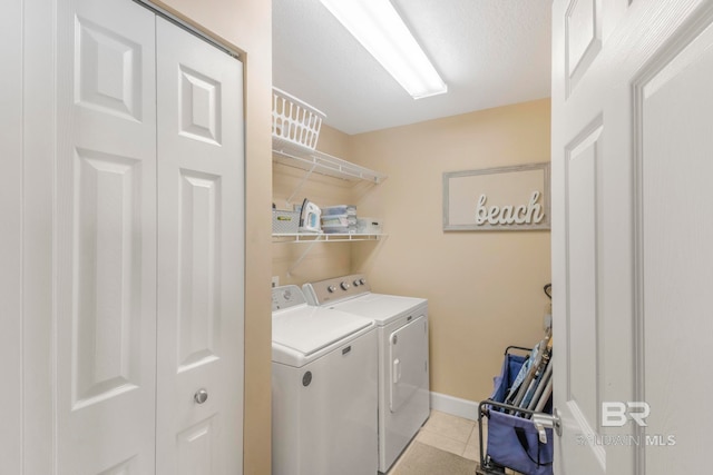 laundry area with light tile patterned flooring and independent washer and dryer