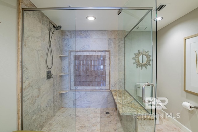 bathroom featuring a stall shower and visible vents