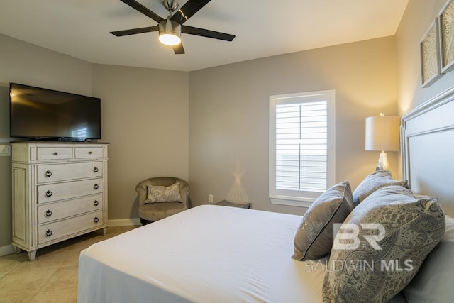 bedroom with light tile patterned flooring, baseboards, and ceiling fan