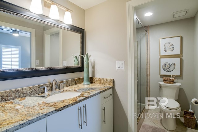 full bath with toilet, vanity, tile patterned floors, and a shower stall