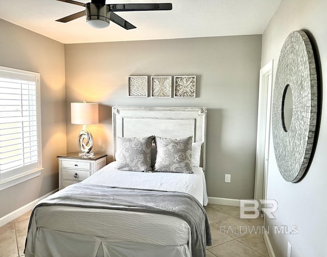 bedroom with baseboards, ceiling fan, and light tile patterned floors