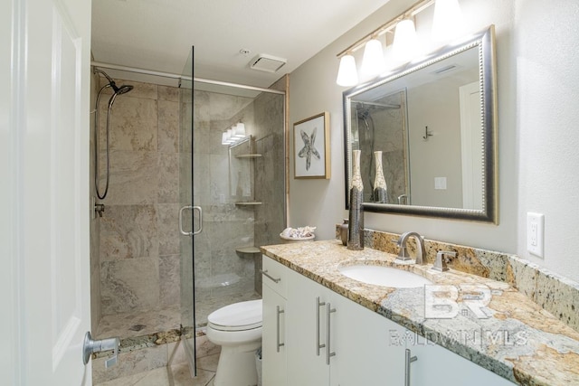 bathroom featuring vanity, toilet, a shower stall, tile patterned floors, and visible vents