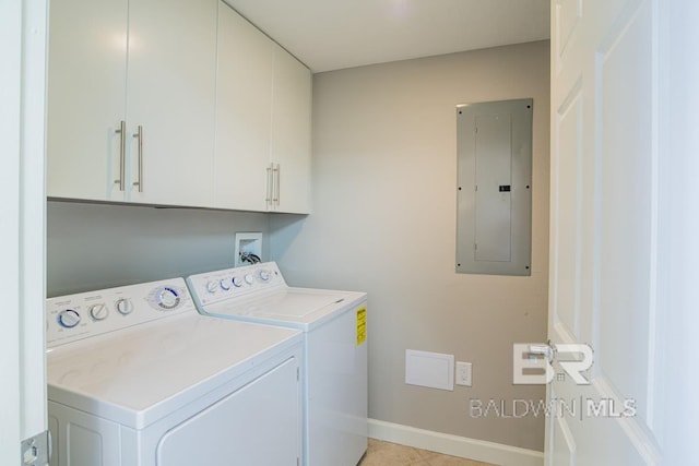 clothes washing area with baseboards, cabinet space, independent washer and dryer, and electric panel